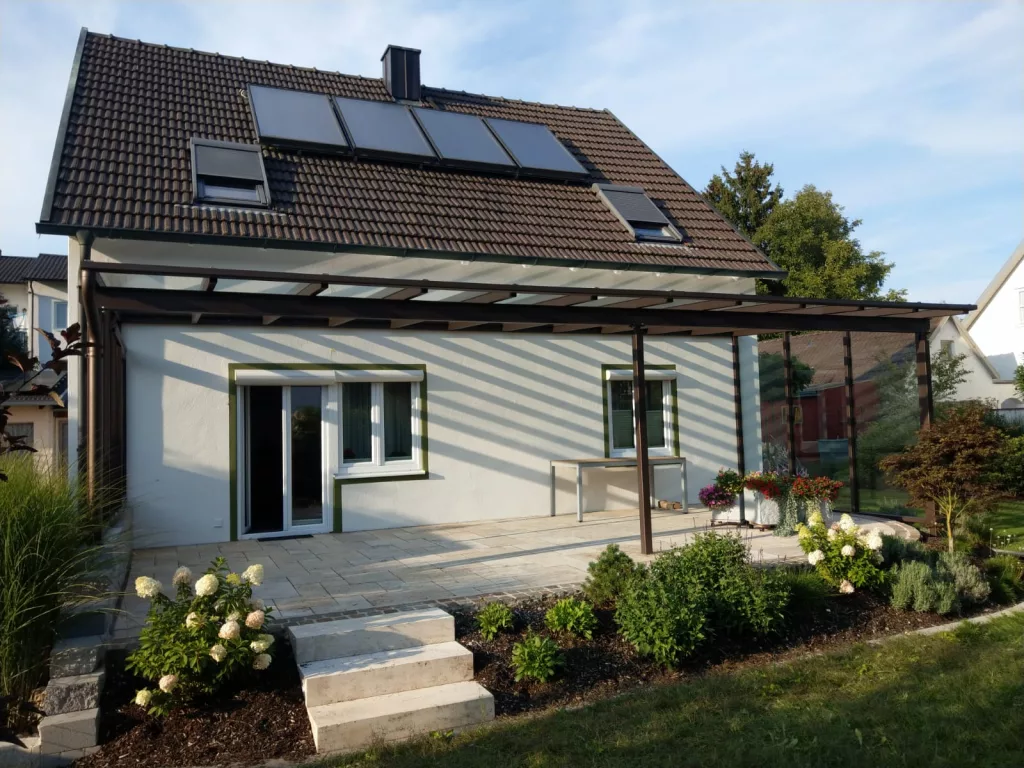 Überdachte Terrassein Altötting, mit Windschutz und Seitenteilen.
